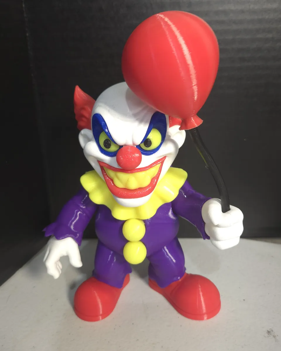 Clown figure holding a red balloon